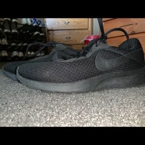All black Nike Roshe running shoe